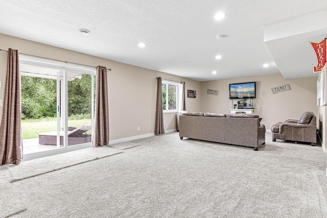 living room with light carpet and a textured ceiling