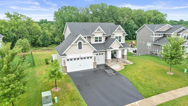 craftsman-style home with a front lawn and a garage