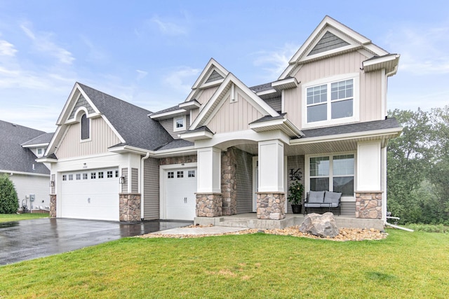 craftsman-style house featuring a front lawn and a garage