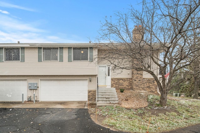 bi-level home featuring a garage