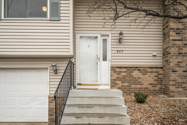 view of exterior entry with a garage