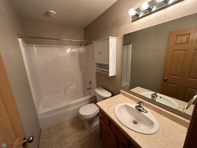 full bathroom featuring toilet, bathtub / shower combination, vanity, and a textured ceiling