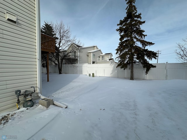 view of yard layered in snow