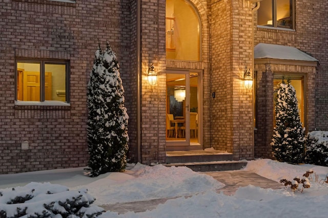 view of snow covered property entrance