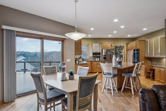 dining space with light hardwood / wood-style floors