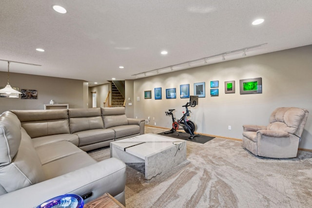 carpeted living room with rail lighting and a textured ceiling