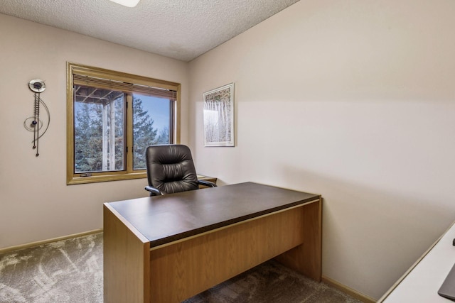 carpeted home office with a textured ceiling