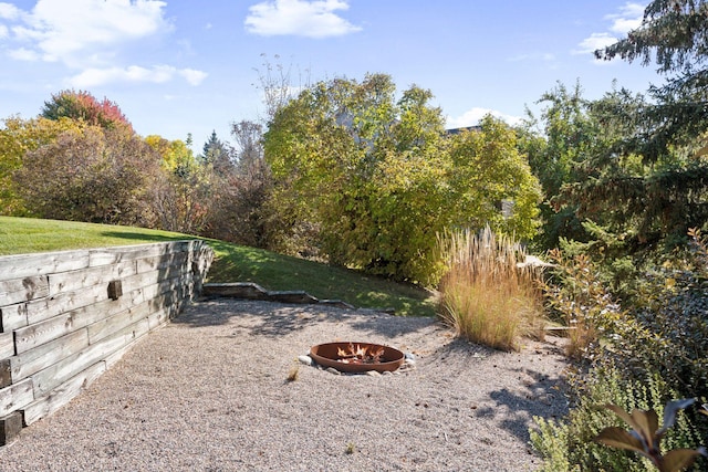 view of yard featuring an outdoor fire pit