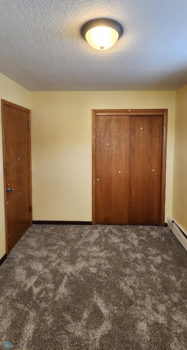 unfurnished bedroom featuring carpet and a textured ceiling