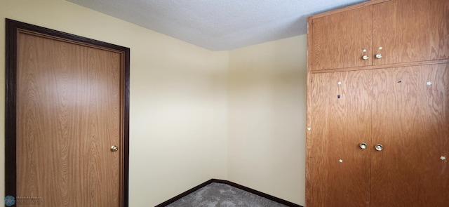 unfurnished bedroom featuring a textured ceiling and carpet floors