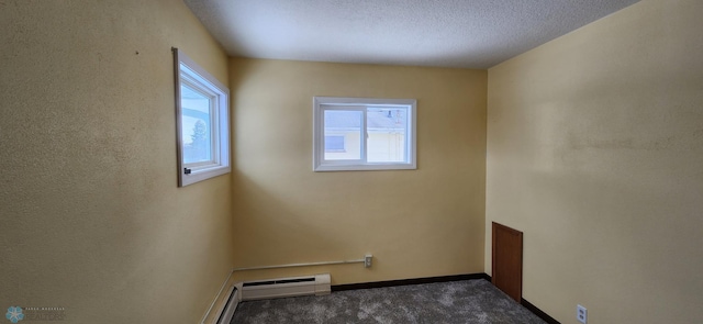 carpeted empty room featuring a healthy amount of sunlight and a textured ceiling