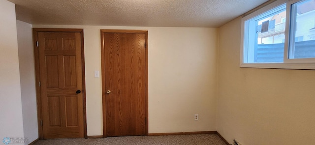 unfurnished bedroom featuring multiple closets, a textured ceiling, and multiple windows