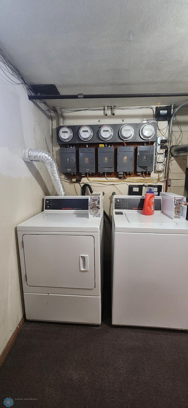 laundry room with independent washer and dryer and a textured ceiling