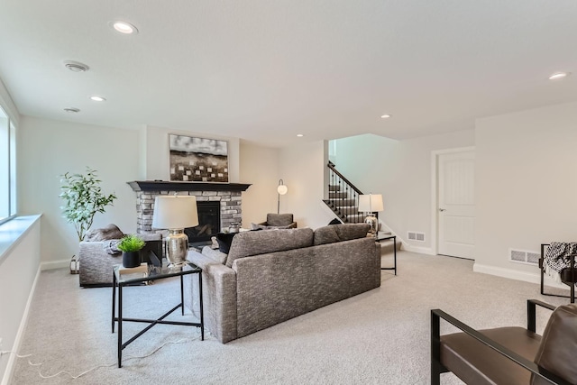 living room with light carpet and a fireplace