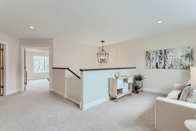 sitting room featuring light carpet and a notable chandelier