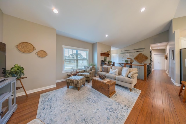 living room featuring wood-type flooring and lofted ceiling