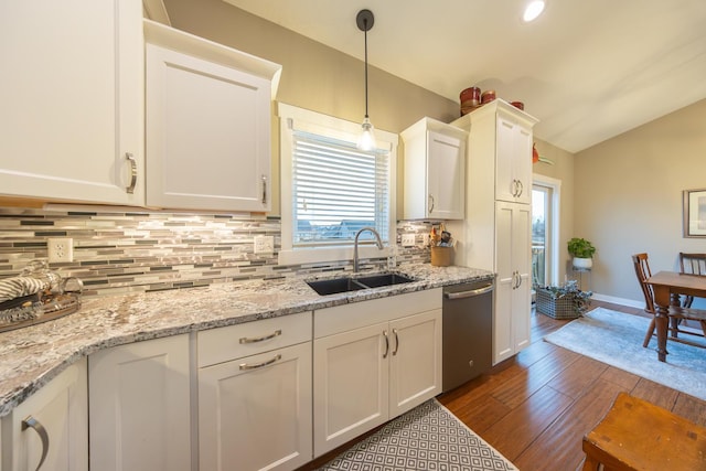 kitchen featuring dishwasher, sink, dark wood-type flooring, light stone counters, and white cabinets