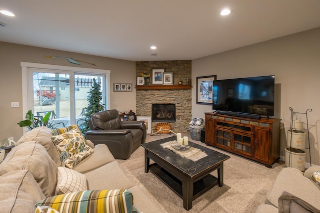 living room with a stone fireplace and light carpet