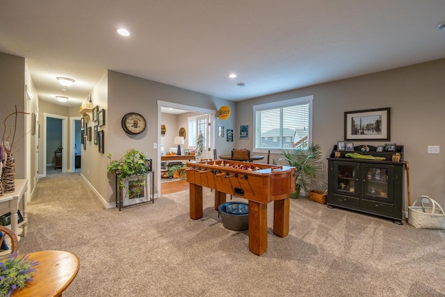 recreation room with light colored carpet