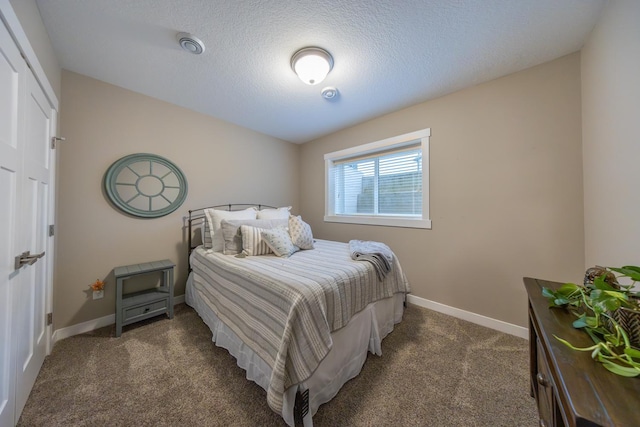 carpeted bedroom with a textured ceiling