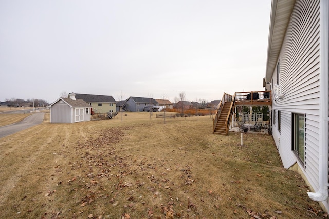 view of yard with a deck and a storage shed