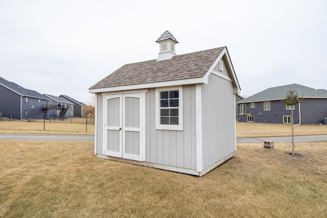 view of outbuilding featuring a yard