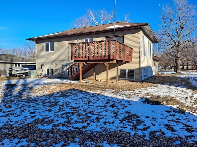 snow covered property featuring a wooden deck