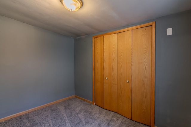 unfurnished bedroom featuring carpet floors and a closet