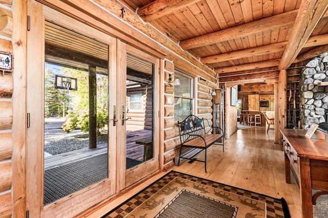 doorway with beam ceiling, rustic walls, wooden ceiling, and wood-type flooring