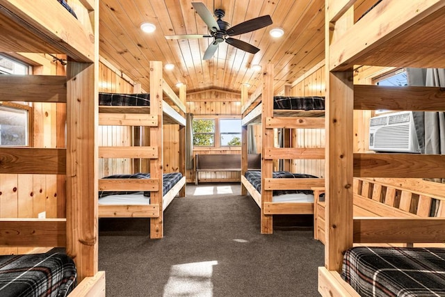 carpeted bedroom with vaulted ceiling, cooling unit, wood walls, and wood ceiling