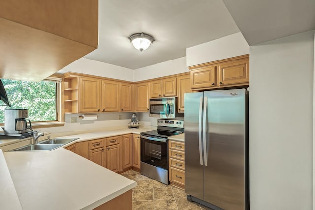 kitchen with kitchen peninsula, sink, and appliances with stainless steel finishes