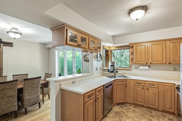 kitchen with dishwasher, plenty of natural light, kitchen peninsula, and sink