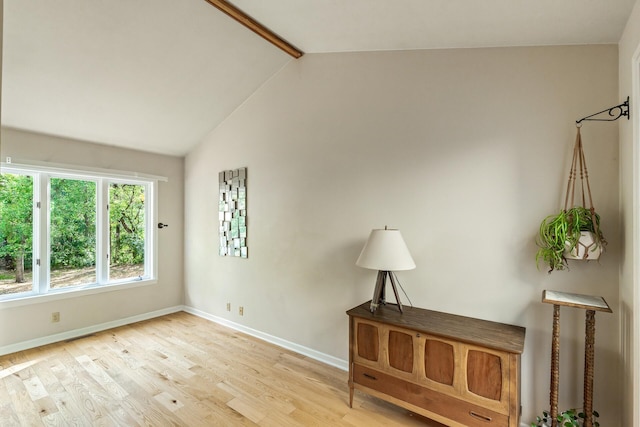 interior space with vaulted ceiling with beams and light hardwood / wood-style floors