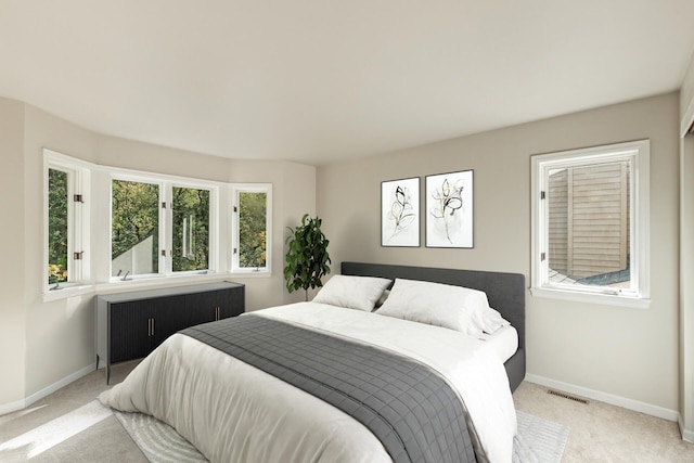 carpeted bedroom featuring multiple windows