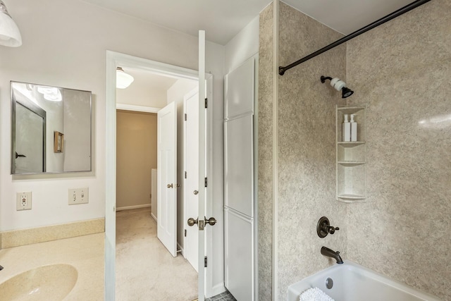 bathroom with tiled shower / bath combo and sink