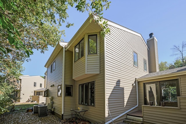 back of house with central air condition unit