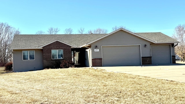 ranch-style house with a garage and a front lawn