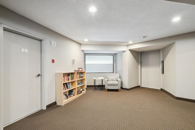 living area with carpet flooring and a textured ceiling