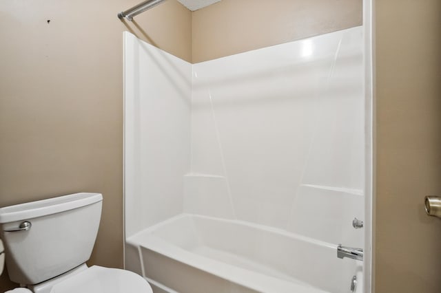 bathroom with bathtub / shower combination and toilet