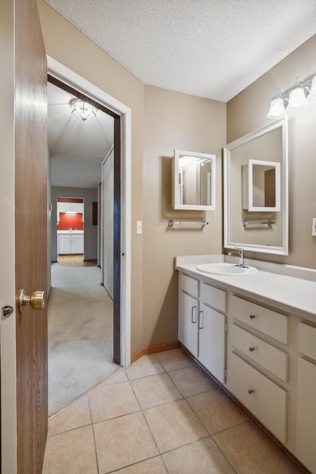 bathroom with vanity, tile patterned floors, and a textured ceiling