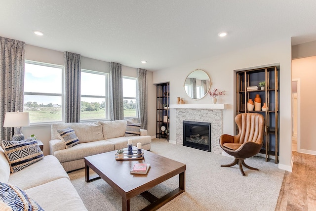 living room with a textured ceiling and light wood-type flooring