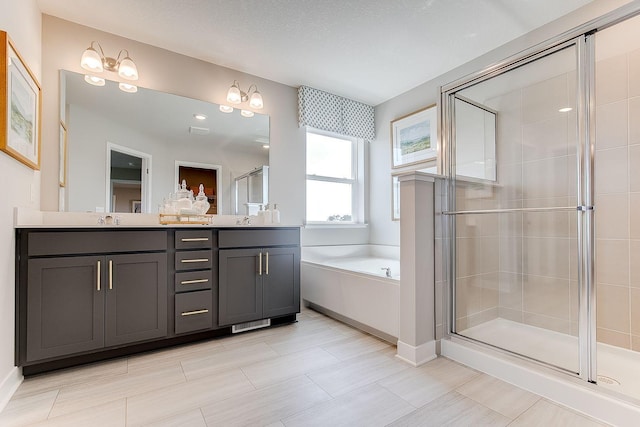 bathroom featuring vanity and independent shower and bath