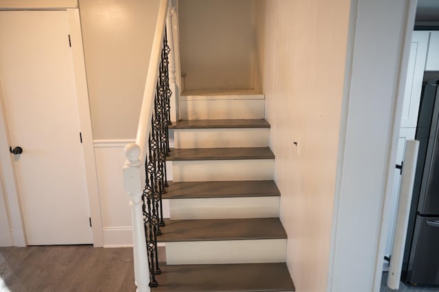 stairs featuring hardwood / wood-style floors