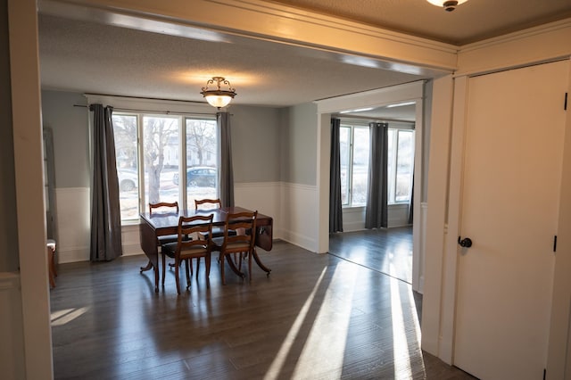 dining area featuring a textured ceiling and dark hardwood / wood-style floors