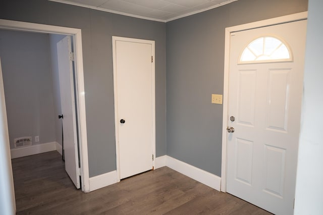 foyer featuring ornamental molding and dark wood-type flooring