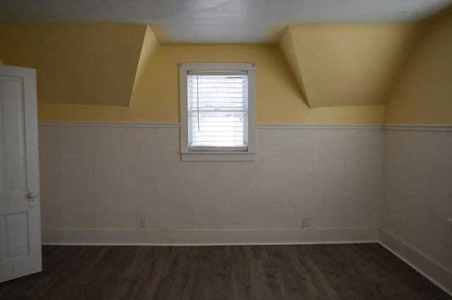 bonus room featuring dark hardwood / wood-style flooring and vaulted ceiling