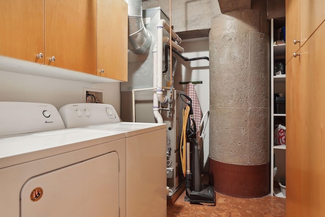 washroom featuring washing machine and dryer and cabinets