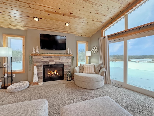 carpeted living room with a fireplace, vaulted ceiling, and wood ceiling