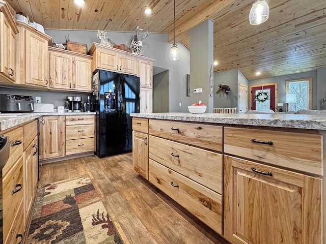 kitchen featuring vaulted ceiling, black fridge, light brown cabinets, hanging light fixtures, and wood ceiling