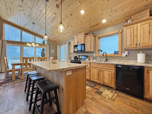 kitchen featuring light hardwood / wood-style flooring, hanging light fixtures, black appliances, wood ceiling, and a kitchen island